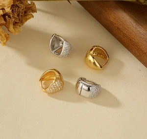 Close-up of S925 sterling silver huggie earrings with polished and pave zircon finish