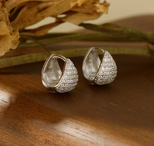 Macro shot of S925 sterling silver stamp on crystal-encrusted teardrop earrings