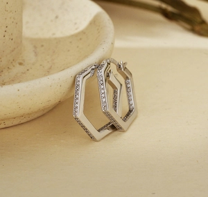 Close-up of hexagonal S925 sterling silver hoop earrings with pavé cubic zirconia