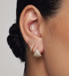 Detail of luxury S925 silver triangle hoop earrings with sparkling zircon on a model