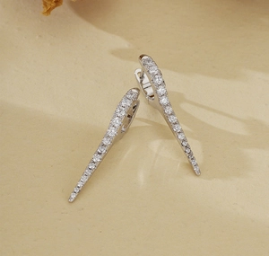 Macro shot of silver drop earrings with shimmering micro-paved zircons and cone design