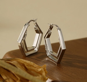 Macro shot of S925 sterling silver geometric hexagonal double-layer hoop earrings