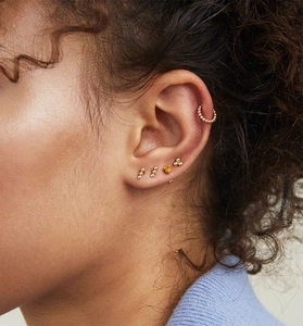 Macro shot of 925 silver gold-plated stud earring set with citrine gemstone