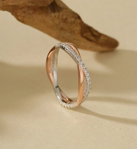 Detail of S925 sterling silver stamp on bicolor intertwined ring with micro pavé diamonds