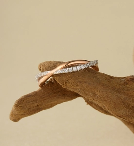 Detail of S925 silver interlocking two-tone ring with micro-pave crystals on wood branch