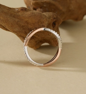 Macro shot of S925 silver and rose gold intertwined band with pavé-set sparkling zircons