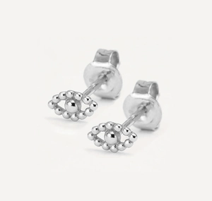Macro shot of silver eye-shaped stud earrings with micro-bead details and butterfly backs