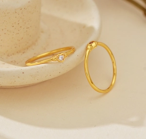 Detailed view of a gold S925 silver heart ring with sparkling pavé zircon stones