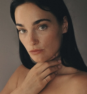 Detailed view of minimalist gold ring and matching necklace worn by a fashion model