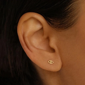 S925 sterling silver evil eye stud earring in gold finish on a female model's ear