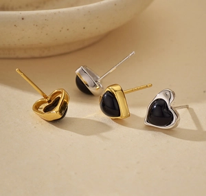 Detailed macro view of S925 sterling silver heart earrings with black agate inlay set