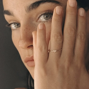 Minimalist S925 sterling silver heart ring with micro-pave diamond on a model's finger