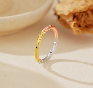 Macro shot of minimalist 925 silver tricolor ring with gold, rose gold and silver finishes