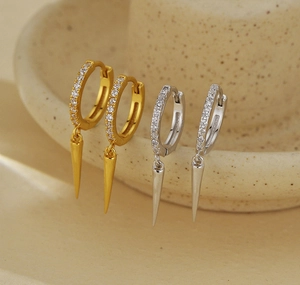 Macro view of gold and silver cone drop earrings with shimmering micro-pave zircons