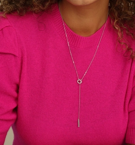 Close-up of S925 sterling silver Y-shaped necklace with green zircon pavé on pink sweater