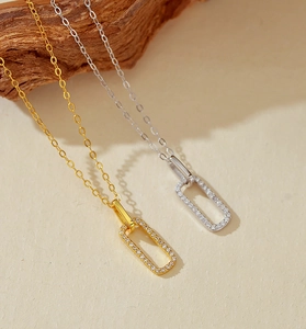 Macro detail of gold and silver rectangle pendant necklaces with pavé zircon setting
