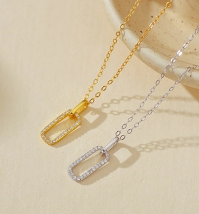Detail of minimalist rectangular geometric necklaces with pavé cubic zirconia in gold and silver