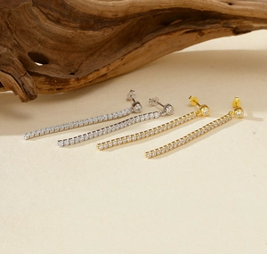 Macro detail of long S925 silver tassel earrings with sparkling cubic zirconia stones