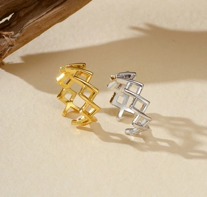 Close-up of gold and silver geometric hollow lattice S925 silver adjustable rings