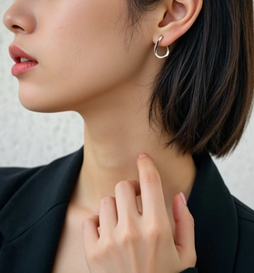 Close-up of minimalist S925 sterling silver irregular geometric hoop earrings on a model