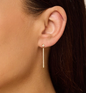 Close-up of elegant gold long tassel earrings with pavé cubic zirconia on model