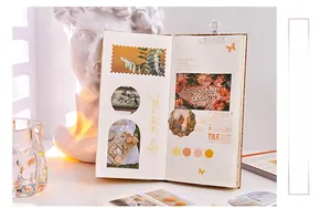 Artistic detail of vintage floral stickers used in a journal with creative shadow lighting