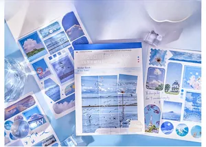 Detailed view of sky-themed scrapbook stickers with scenic nature designs and blue aesthetics