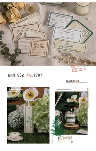 Detail of vintage scrapbooking stickers featuring botanical line art and old postage stamps