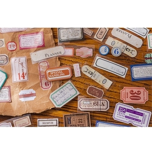 Vintage DIY scrapbooking tape set with retro ticket and stamp designs on wooden background