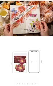 Floral stationery stickers with gold foil details next to phone for size scale