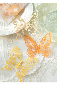 Detailed laser-cut paper butterflies with floral lace patterns for scrapbooking decor