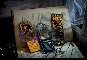 Detail of vintage bookmarks with fairy themes and laser effects on an old book