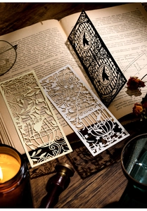 Close-up of laser-cut hollow bookmarks featuring vintage bird and floral silhouettes