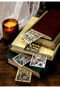 Detailed view of vintage hollow bookmarks featuring nature patterns among old books