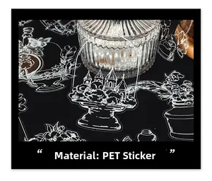 Macro shot of white hand-drawn PET stickers with vintage bottles and castle on dark background