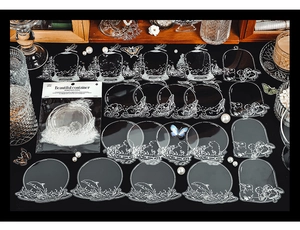 Detailed view of clear PET stickers with white outlines of animals and glass containers