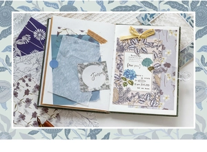 Detailed close-up of retro floral paper ephemera and vintage stickers on a green journal