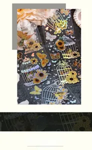 Detail of vintage laser gold PET stickers featuring birdcages, sunflowers and butterflies
