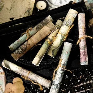 Vintage scrapbooking paper set with floral and clock patterns on old typewriter