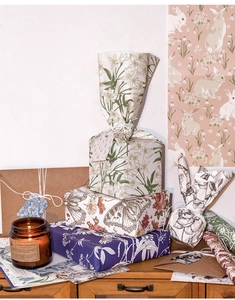 Detail of vintage botanical scrapbook materials with floral and forest rabbit patterns