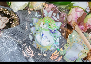 Macro detail of holographic PET floral stickers with gold stamping for DIY journaling