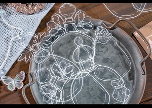 Macro view of floral PET stickers with gold foil details in a vintage tray setting