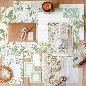 Vintage botanical stationery set with hand-drawn floral papers and envelopes on wood