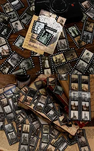 Close-up of vintage film-style stickers with retro architecture and scenery for journaling
