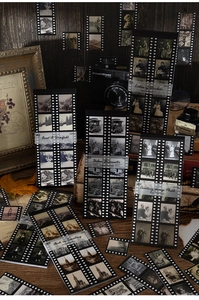 Detail of vintage film-style stickers with antique camera and wooden background