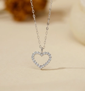 Close-up of S925 sterling silver hollow heart pendant necklace with pavé cubic zirconia