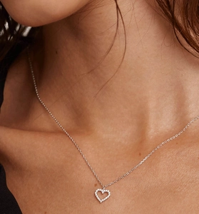 Close-up of sparkling 925 sterling silver hollow heart pendant necklace on model's neck