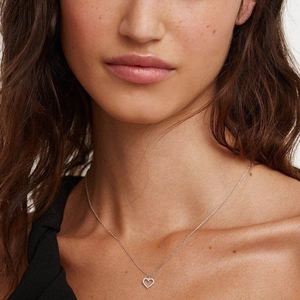 925 sterling silver hollow heart pendant necklace with zircon worn by a female model
