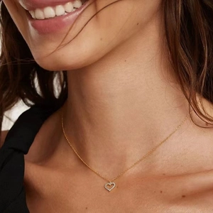 925 silver hollow heart necklace with zircon inlay worn on a neck in golden finish
