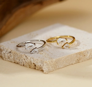 Detail of S925 silver open ring featuring dual pear-cut zircon stones on a stone base